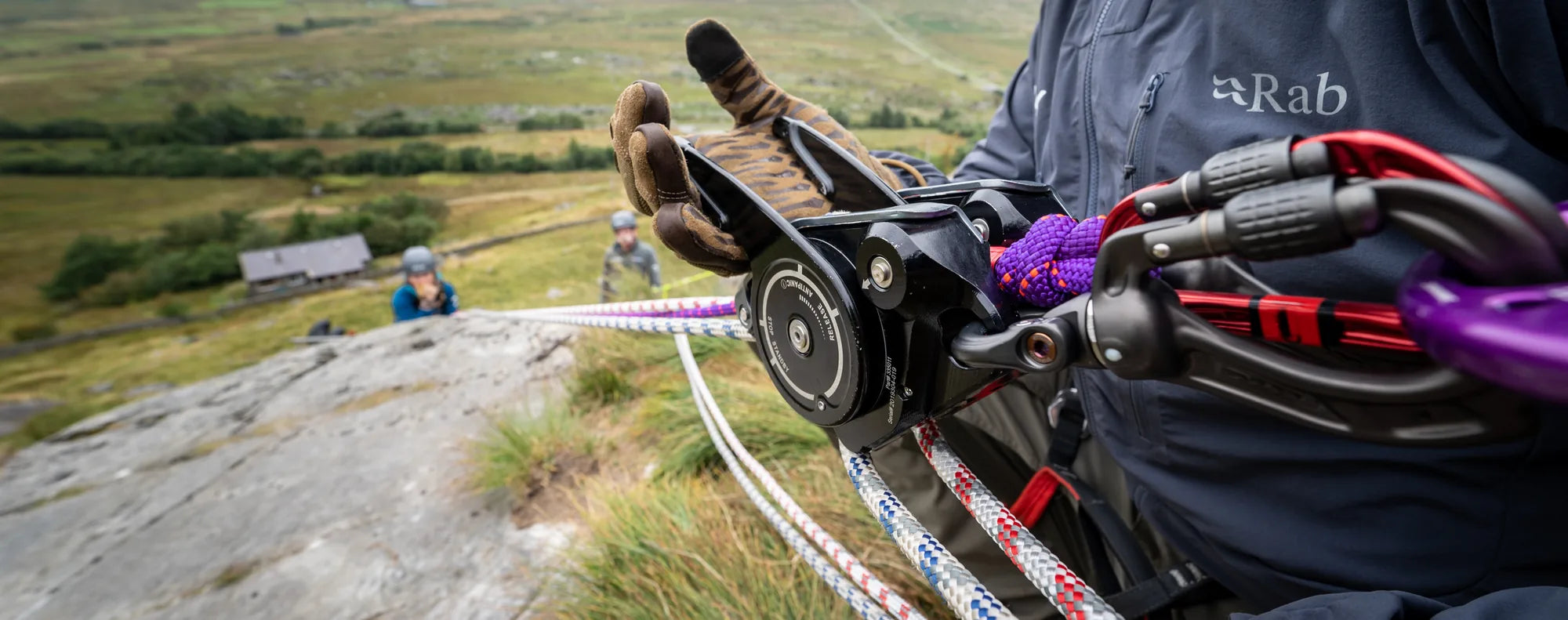Student abseiling on a steep mountain crag in Snowdonia during a steep ground and technical rope course