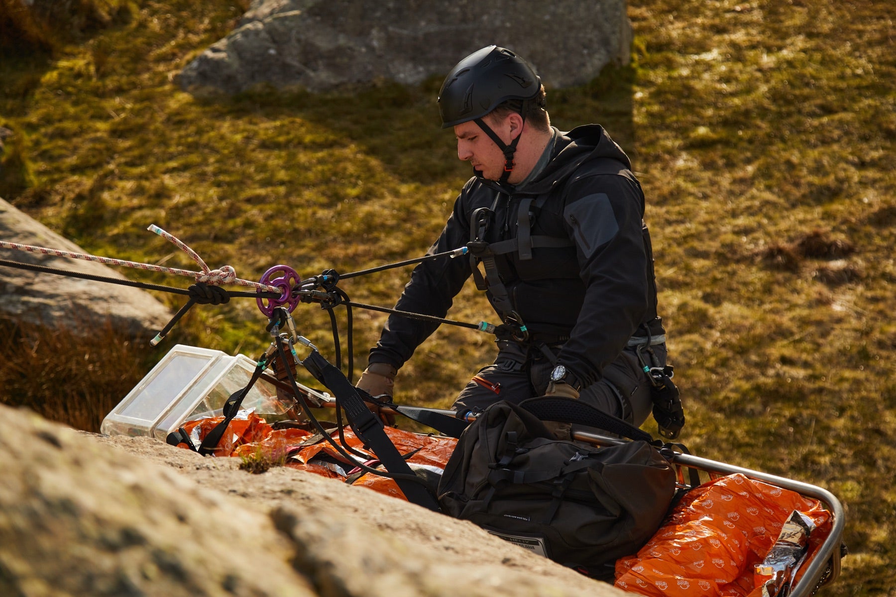 Close up of a medic and a stretcher over a mountain during an advanced first aid and trauma response course